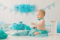 A one-year-old boy tries his first birthday cake. Anniversary Party Royalty Free Stock Photo