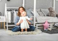 One year old girl playing near in the room with a toy horse, ska Royalty Free Stock Photo