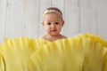 One year old girl sitting in handmade paper green cabbage. Portrait. Royalty Free Stock Photo