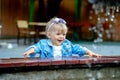 One year old girl smiling near the fountain Royalty Free Stock Photo