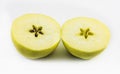 One yellow apple cut in half on a white background Royalty Free Stock Photo