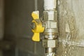 One yellow dirty iron valve on a gray metal gas pipe near Royalty Free Stock Photo