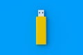 One yellow flash drive, usb memory stick on blue background Royalty Free Stock Photo