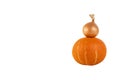 One yellow onion and an orange pumpkin are stacked in the form of a pyramid, white isolated background