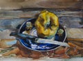 One yellow ripe quince on the blue plate on rustic wooden plank