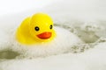One yellow rubber duck with soap bubble bath, light background with bubbles. Kids spa concept. Children`s bath time concept Royalty Free Stock Photo
