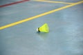 one yellow shuttlecock on the edge of the badminton court Royalty Free Stock Photo