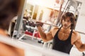 Young adult weightlifter picking up barbell