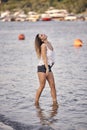 One young beautiful girl, casual summer clothes, knees in water river Royalty Free Stock Photo