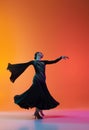 One young beautiful woman in stage dress dancing ballroom dance isolated over gradient orange pink background in neon Royalty Free Stock Photo
