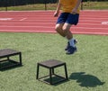 One young boy jumping ont to a small plyo box Royalty Free Stock Photo