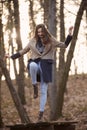 One young cute girl, standing on table with one leg, finding balance, Royalty Free Stock Photo