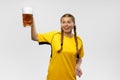 One young excited woman in yellow football kit holding beer mug and supports favorite team. Soccer fans, competition Royalty Free Stock Photo