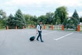 One Young Handsome Guy Arab Businessman Entrepreneur Tourist Traveler Visitor go With Suitcase For Trip in His Hand in Royalty Free Stock Photo