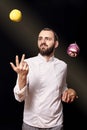 One young man, chief uniform, throwing food, studio photoshoot, having fun.