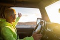 One young man driving his car and looking at the sunset enjoying his vacations and holiday outdoor alone - travelling and journey Royalty Free Stock Photo