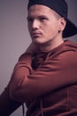 One young man, early 20s, boyish looks, posing in studio, casua