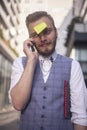 One young silly man, posing with post-it note attached glued to his forehead Royalty Free Stock Photo