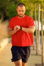 One young man walking and checking time on watch Royalty Free Stock Photo