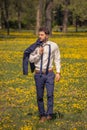 One young man, walking outdoors flowers field, suit formal cloth Royalty Free Stock Photo