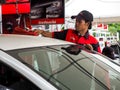 One young service mechanic cleaning automobile car at auto Wash a car shop