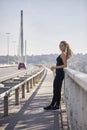 One young smiling woman, 20-29 years old, posing on bridge Royalty Free Stock Photo