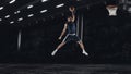 One young sportsman basketball player training in gym, idoors isolated on dark background. Concept of sport, game Royalty Free Stock Photo