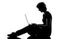 One young teenager boy or girl silhouette computer computing lap Royalty Free Stock Photo