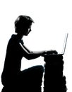 One young teenager boy or girl silhouette computer computing lap Royalty Free Stock Photo