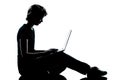 One young teenager silhouette computer computing Royalty Free Stock Photo