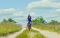 One young woman - an athlete in a helmet riding a mountain bike outside the city Royalty Free Stock Photo