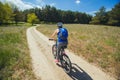 One young woman - an athlete rides on a mountain bike outside of town in a pine forest Royalty Free Stock Photo