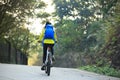 Woman cyclist riding mountain bike on forest trail Royalty Free Stock Photo