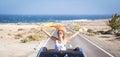 One young woman enjoying and having fun in their vacations outdoors - female person in freedom concept and lifestyle with a car in