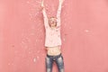 One young woman happy with arms outstreched high in air with confetti thrown, 20-29 years old, long blond hair. Royalty Free Stock Photo