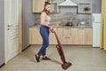 One young woman uses a wireless vacuum cleaner Royalty Free Stock Photo