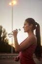 One young woman, 20-29 years, drinking water from a bottle. Royalty Free Stock Photo