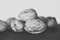 Black and white photo walnuts stacked with black background