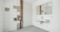 Bathroom Renovation with Exposed Pipes and White Walls Wallboard Drywall Installation Project Reflecting Brightness in Royalty Free Stock Photo