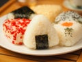 Onigiri of various shapes and fillings on a plate. Close-up food photo. Japanese rice ball