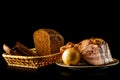 Onion and bekon in the plate and loaf of fresh rye bread with slices isolated on a black background. Royalty Free Stock Photo