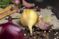 onion bulb and other spices on the table while cooking dishes