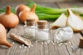 Onion bulbs, green onions and bottles of homeopathic globules. Homeopathic remedies Royalty Free Stock Photo