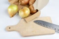 Onion on a chopping board on a white kitchen table. Vegetables f Royalty Free Stock Photo