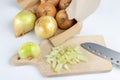 Onion on a chopping board on a white kitchen table. Vegetables f Royalty Free Stock Photo