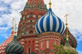 Onion domes of St. Basil`s Cathedral on Red square in Moscow closeup against blue sky with white clouds Royalty Free Stock Photo