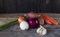 Onion , garlic , potato , carrot , on a wooden table. Healthy food. Organic vegetables on wood Royalty Free Stock Photo