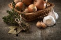 Onion, garlic, sheaf thyme, bay leaf in a wicker basket whi Royalty Free Stock Photo