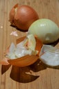 Onion halves on a cutting board, one half peeled Royalty Free Stock Photo