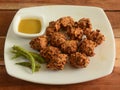 Onion pakoda served with sauce, a famous midday snack in india